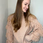 sweater with fringe detail on sleeves